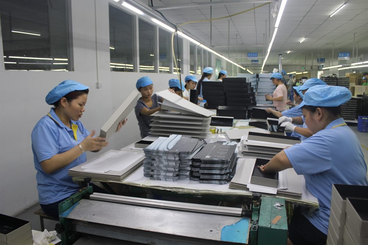 Workers assembling rigid paper boxes